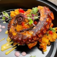 Pulpo Anticuchero (Grilled Octopus) · Grilled Octopus, Potato, Peruvian yellow and red peepers, cilantro with aji panca sauce.  