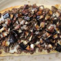 Mediterranean Flat Bread · Tedbile on hummus topped with eggplant and tehine