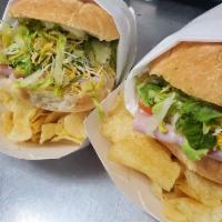 Tortas · Sandwich made with lean ham, avocado, serrano peppers, tomatoes, mustard and mayo; with chip...