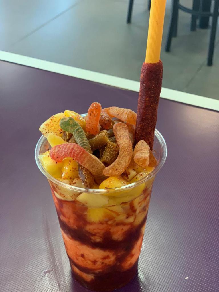 Chamomix · 20oz cup with homemade chamoy mixture and two scoops of your choice of mango or lime ice cream, prepeared with mango chunks on top and tamrind candies with a tamarind stick candy with a chamoy drizzle and tajin on top.
Vaso de 20oz con Chamoy hecha en casa con tu opcion de nieve de mango o limon. Preparados con Mango arriba y dulces de tamarindo y una tamarocca de tamarindo y mas chamoy y tajin por arriba.