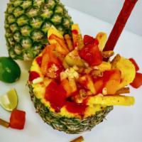 Pinaventura con Fruta · Cut in Half pineapple stuffed with a fresh fruit coctel mix inside with pineapple cuts aroun...