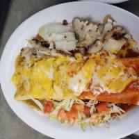The Company Burrito · 2 eggs, cheese, choice of meat. Smothered with red or green chile, topped with melted cheese...