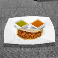 Deshebrada (shreded beef on red sauce) · Shredded beef on red sauce.