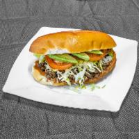 Tortas · Bolillo bread sandwich with refried beans, choice of meat, lettuce, tomatoes, onions, avocad...