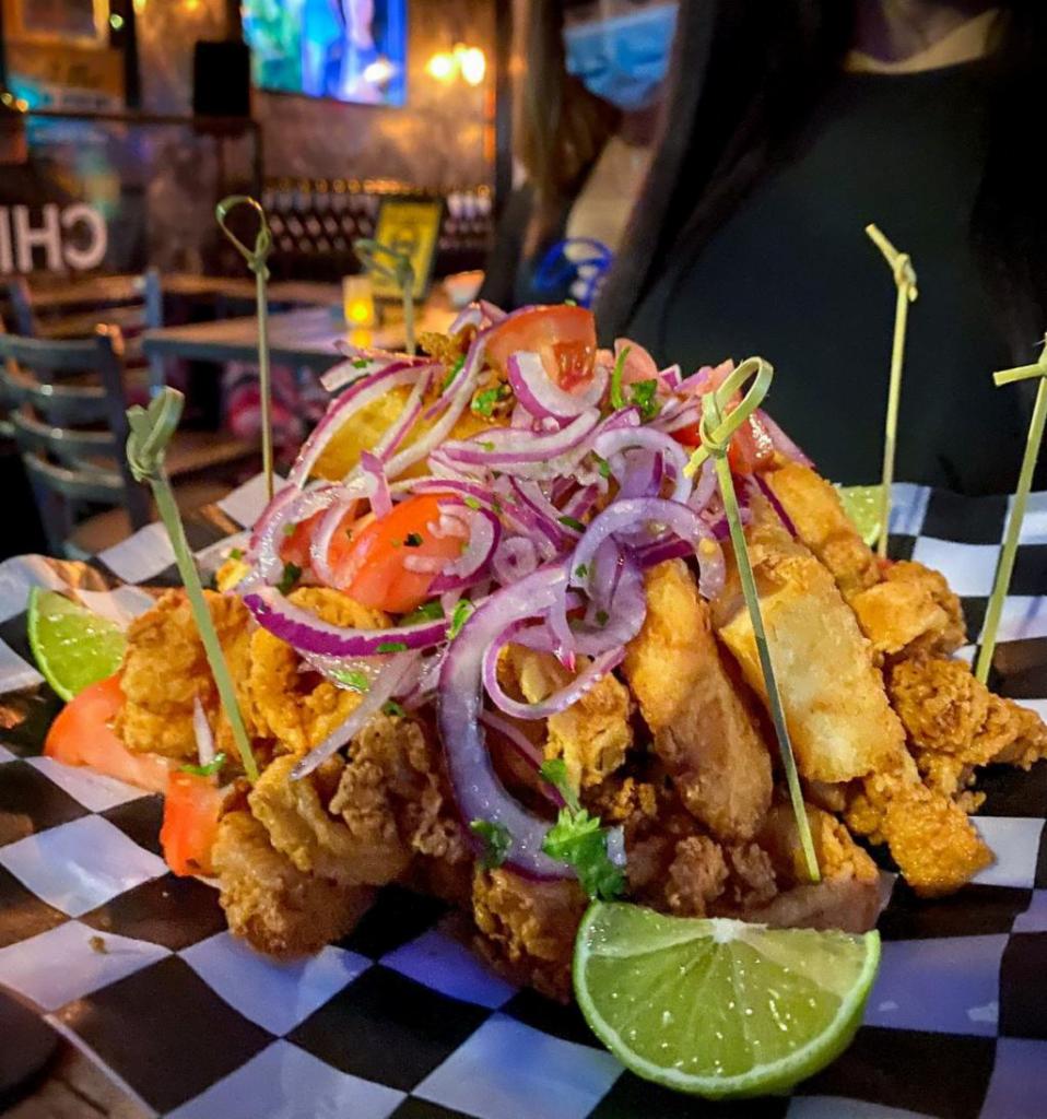 Peruvian Jalea · Combination of fried seafood including shrimp, calamari, and tilapia fish. Served with yucca, onion, and traditional salsa criolla.