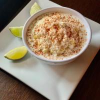 Esquite · Corn kernels, chile Tajín, mayo, Sour cream, Cotija cheese and lime juice
