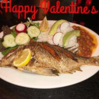 Mojarra Frita · Fried whole Tilapia with rice, refried beans and Salad.