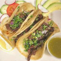 Skirt Steak Taco · 3 tacos served with onions and cilantro.