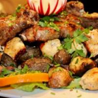 73. Lamb Shish Kebab · Special marinated cubes of baby lamb grilled to delight on skewers. Served with rice and sal...
