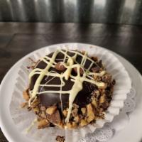 Decadent Chocolate Muffin · Devils Food Chocolate cake dipped in house-made ganache, chopped heath bar, drizzled with wh...