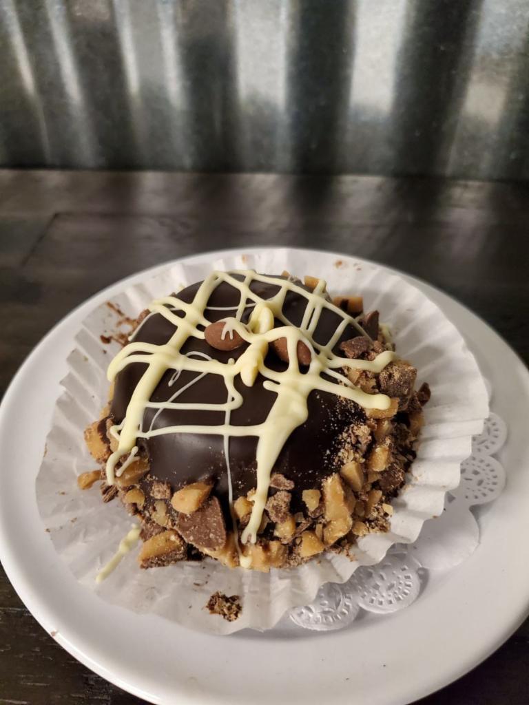 Decadent Chocolate Muffin · Devils Food Chocolate cake dipped in house-made ganache, chopped heath bar, drizzled with white chocolate