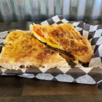 Breakfast Panini · Our house-made ciabatta bread, layered with scrambled eggs, cheddar cheese, sliced tomato, c...