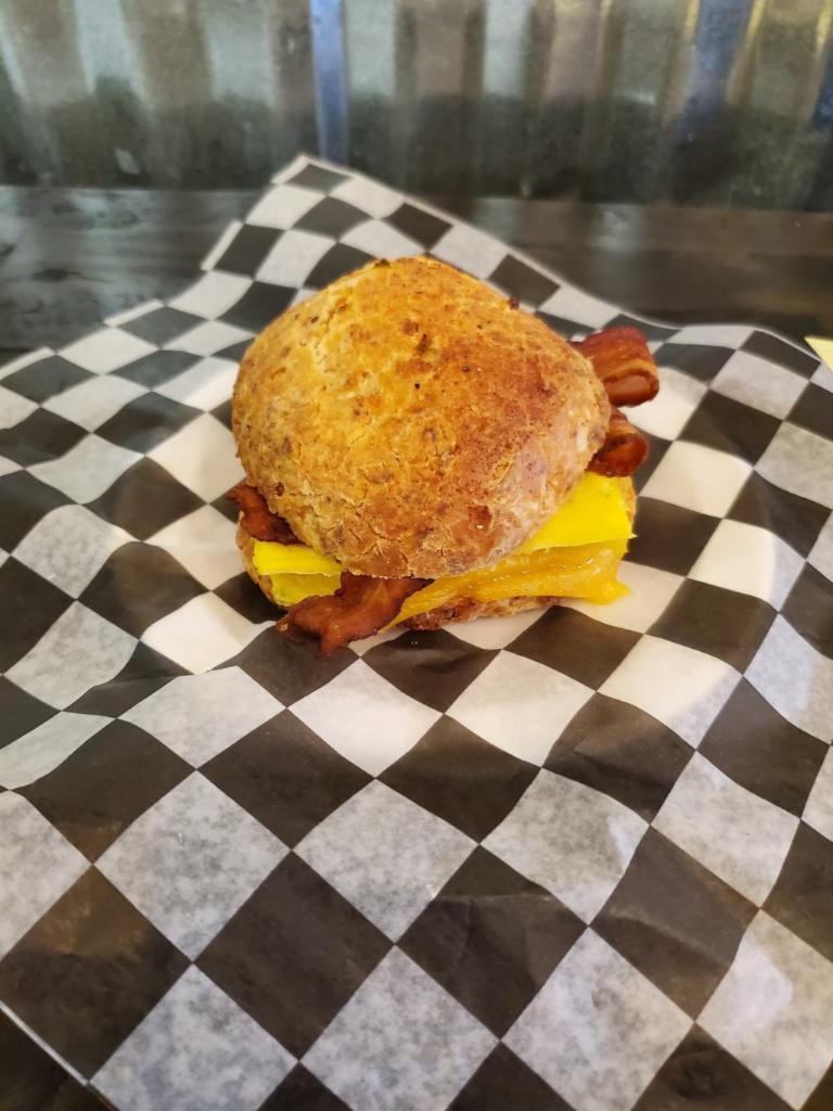 Biscuit Breakfast Sandwich · A house-made green onion cheddar buttermilk biscuit, layered with eggs, and your choice of sausage, ham, bacon, or roasted veggies.