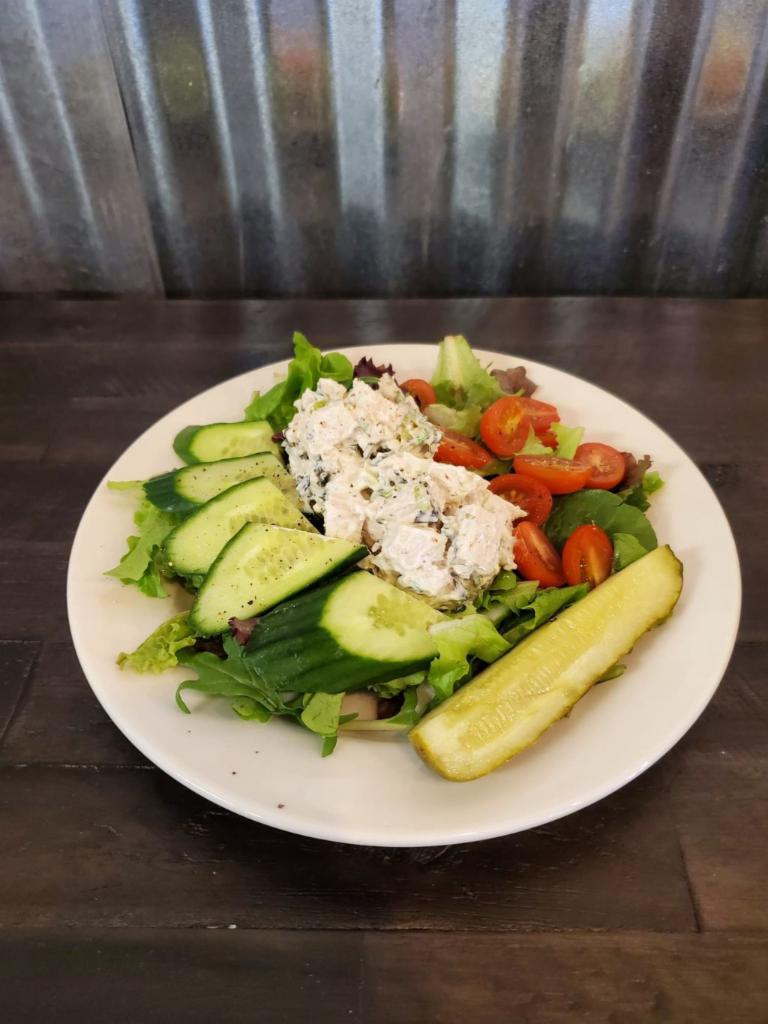 Lemon Basil Chicken Salad · House-made chicken salad with mixed greens and sliced tomato or have it as a salad on a bed of mixed greens with a side of dressing.