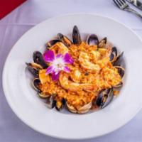 Seafood Risotto · Clams, mussels, shrimp, scallops, white wine tomato sauce