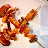 Kushiyaki · Boiled shrimp, fish and scallops on skewer with teriyaki sauce.
