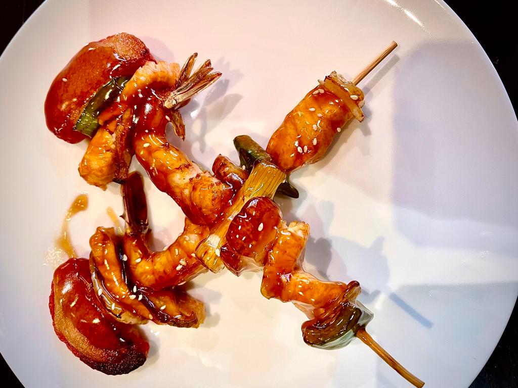 Kushiyaki · Boiled shrimp, fish and scallops on skewer with teriyaki sauce.