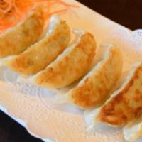 Gyoza · Pork dumplings with vinegar dipping sauce.