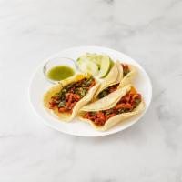 27. Al Pastor Taco · 3 pieces. Tacos include onion, cilantro, and sauce.