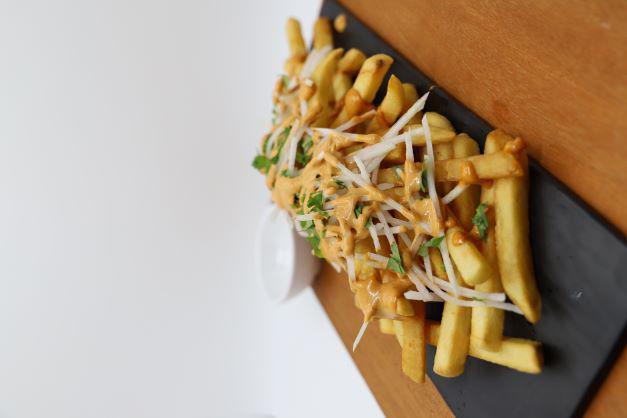 Moomoo Fries · Golden brown potato fries with our house made pickled radish, and chipotle mayo 