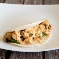Grilled Chicken Taco · Poblano peppers, diced onions, sliced mushrooms, pepper jack cheese, and a chipotle sour cre...