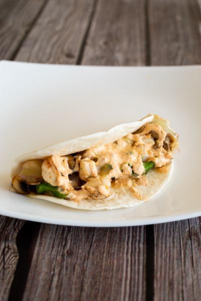 Grilled Chicken Taco · Poblano peppers, diced onions, sliced mushrooms, pepper jack cheese, and a chipotle sour cream sauce in a flour tortilla.