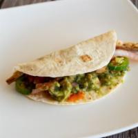 Chicken Fajita Taco · Jalapeno peppers, sliced onions, and guacamole with a papaya salsa in a flour tortilla.