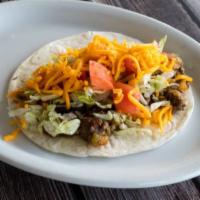 Ground Beef Taco · Loaded with fried potatoes, cheddar cheese, diced onions, green chiles, lettuce, and diced t...