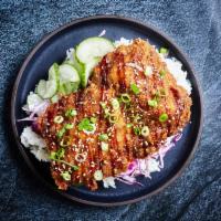 Donkatsu Rice Bowl · Lightly fried chicken cutlet with cabbage, pickled cucumbers, sesame seeds, rice, and Donkat...