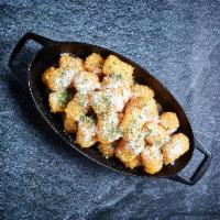 Parmesan Truffle Tots · Tater tots with fresh Parmesan cheese, white truffle oil and chives.