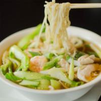 Pho · Vietnamese style rice noodle soup served with bean sprouts and basil on the side.