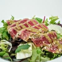 Pepper Tuna Salad · Seared Black pepper tuna with green mix, japanese dressing on top.