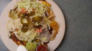 Nachos Grande  · Tortilla chips topped with chili con carne, diced tomatoes, jalapenos, melted cheeses, salsa...