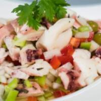 Ensalada de Pulpo · Octopus salad. Bite size octopus, peppers, onions, cilantro, green olives, with lime olive o...