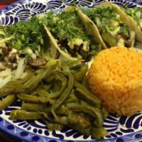 Fish Taco a La Mex · Flour soft corn tortillas, served with onion, cilantro and choice of meat with a side of ric...
