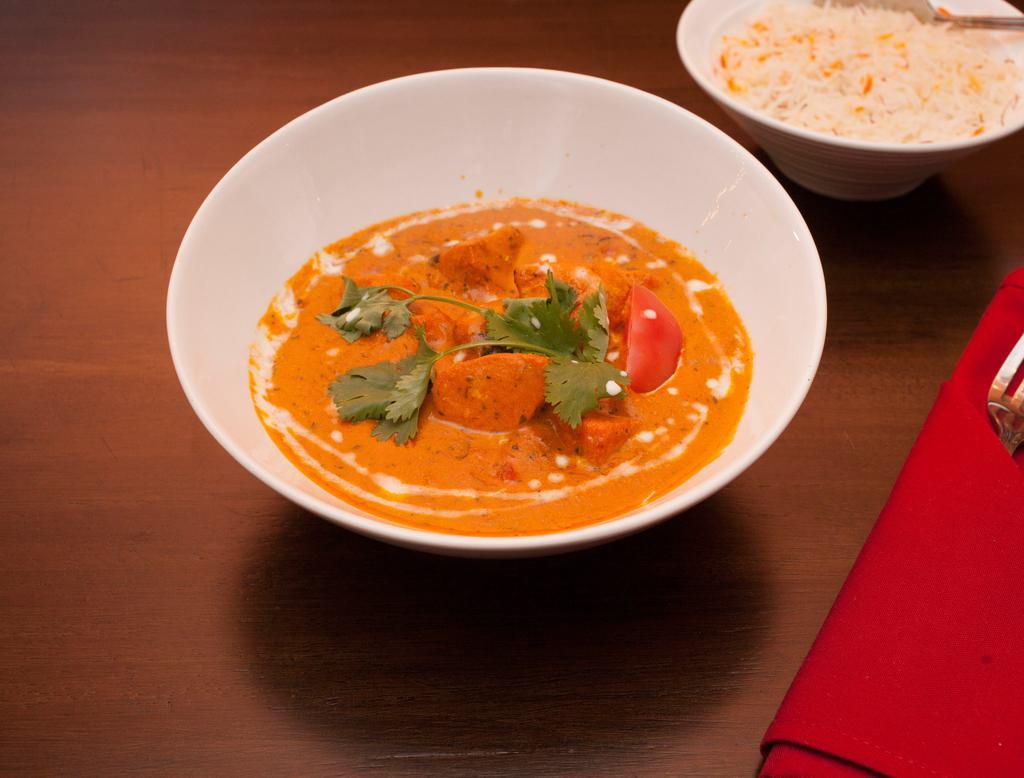 Chicken Tikka Masala · Boneless chicken marinated in herbs and spices, barbecued. Cooked with cream and almonds. Served with basmati rice.