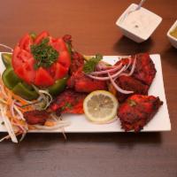 Tandoori Chicken · Spring chicken marinated in mild spices and barbecued.