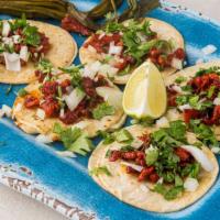 Pastor Tacos (5) · Al Pastor on a corn tortilla topped with onions and cilantro, limes and one side of salsa 
 ...