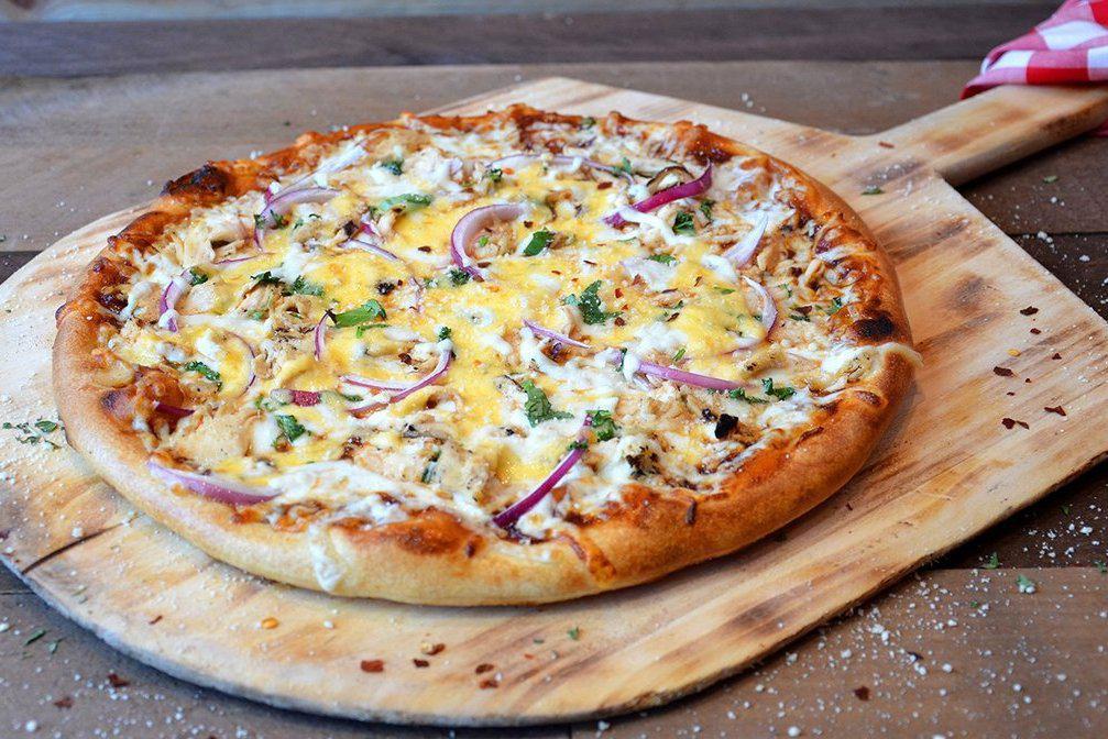 BBQ Chicken Pizza · Grilled chicken and onions, sweet BBQ sauce, fresh cilantro, smoked gouda and mozzarella cheese.
