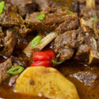 Lamb Vindaloo · Boneless lamb simmered in chili vinegar with potatoes, tomato, and onion sauce. Served with ...