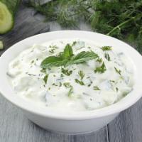 Cacik · Finely chopped baby cucumbers blended with garlic yogurt, mint, dill, and olive oil.