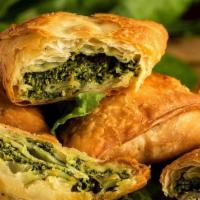 Spinach Pie · Ispanakli borek. Served with onions and feta cheese.