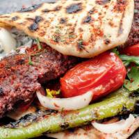 Adana Kebab Entree · Ground lamb, red peppers, herbs and spices served char-grilled on skewers.