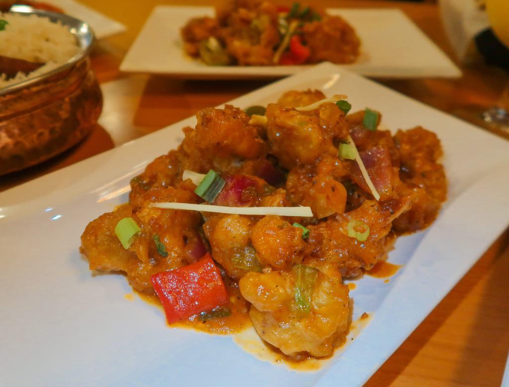 Gobi Manchurian · Crispy cauliflower florets tossed in a spicy, sweet and tangy manchurian sauce. Vegan, gluten friendly.