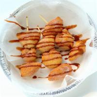Doughnut Kabobs · Fried dough balls covered in cinnamon sugar and drizzled with Nutella sauce