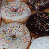 Sprinkle Donut · Donut with a hole in the center and chocolate or vanilla icing with Rainbow sprinkles
