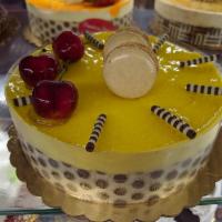 Mango Mousse Cake · Mango Mousse layered with Vanilla cake