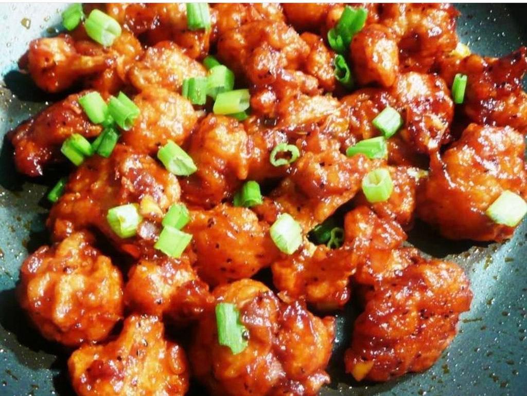 Gobi Manchurian  · Cauliflower florets tossed in a soy garlic sauce with a hint of chili. Spicy.