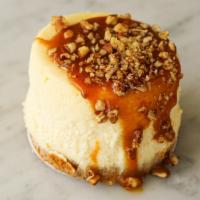 Caramel Pecan Cheesecake to go · Rich vanilla bean cheesecake topped with caramel and toasted pecans, finished with a graham ...