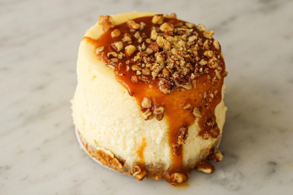 Caramel Pecan Cheesecake to go · Rich vanilla bean cheesecake topped with caramel and toasted pecans, finished with a graham cracker crust.